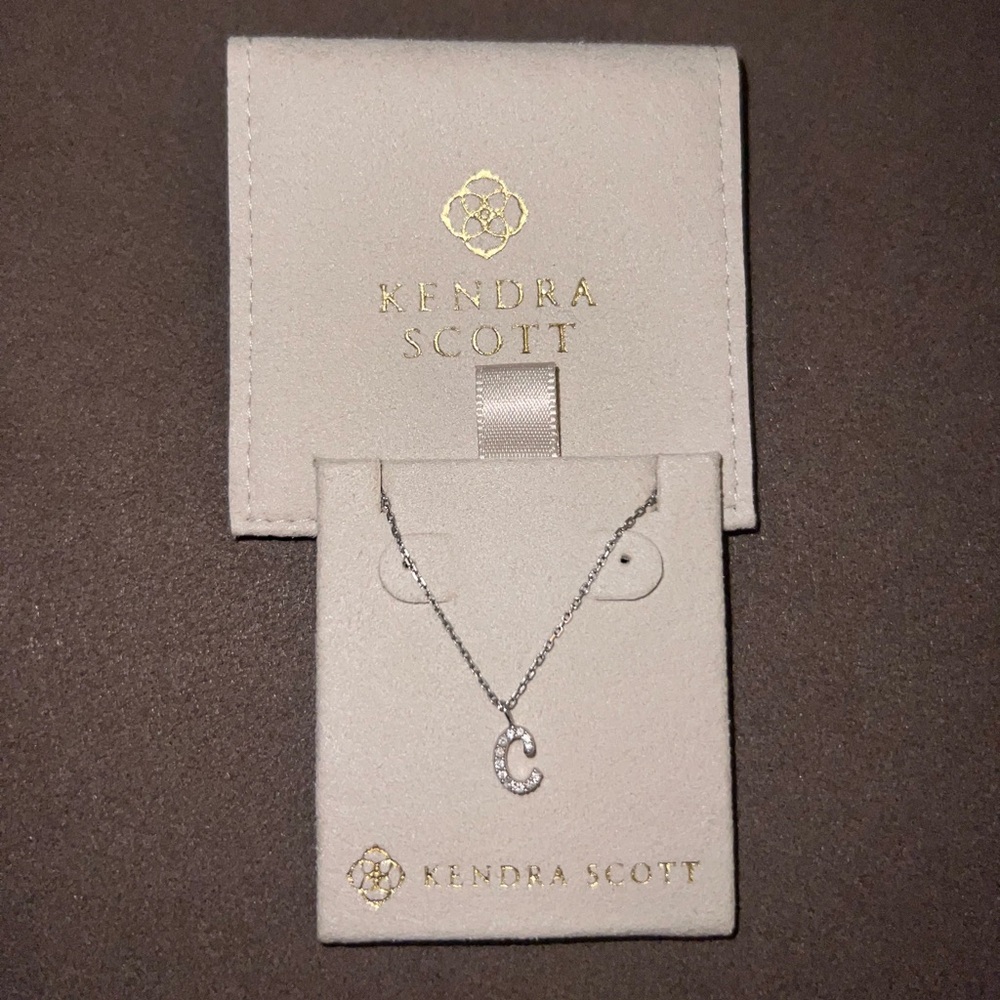 14k white gold and diamond C initial necklace.
